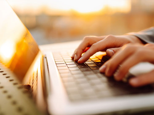 laptop typing sunset workspace